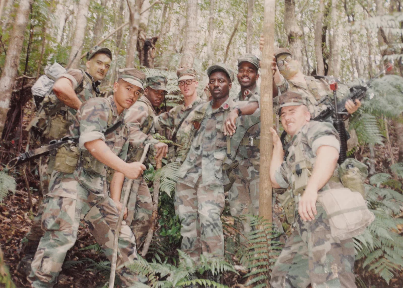 Marines gathered in a wooded training area