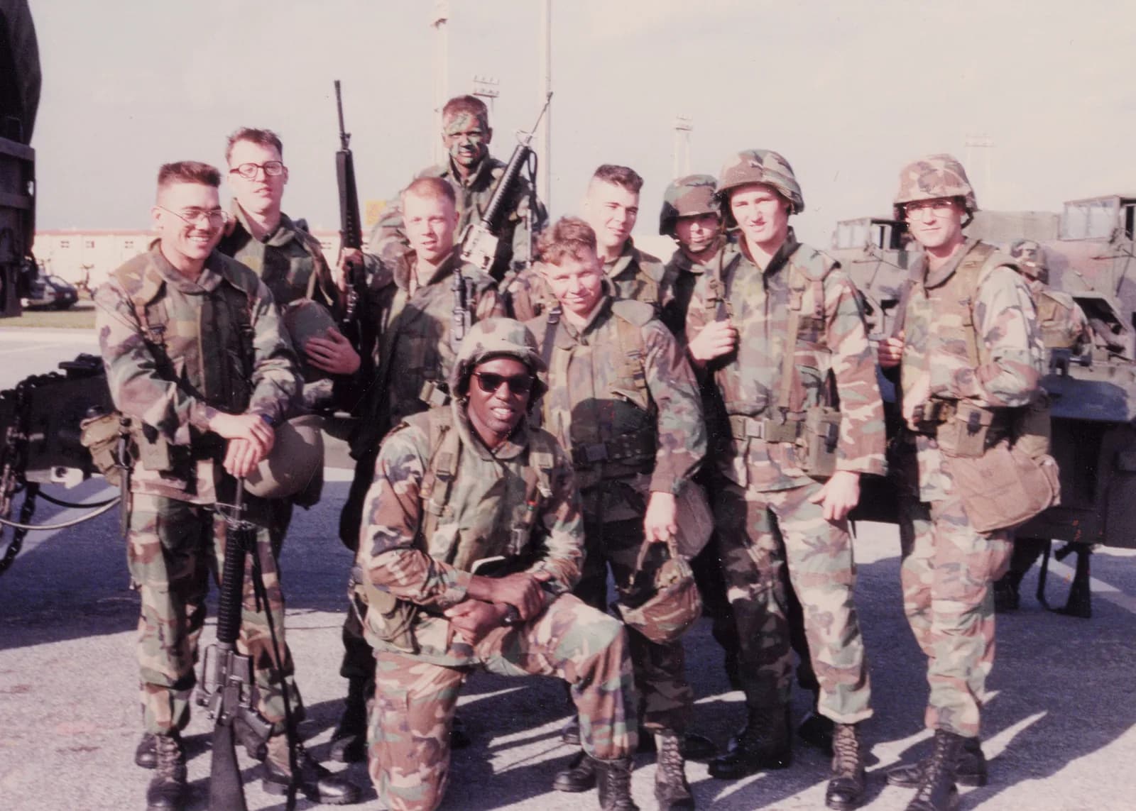 Marines posing together near military vehicles
